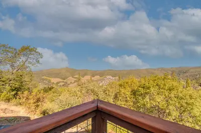 a view from the top of a deck with mountains in the background at Murphys View in Murphys