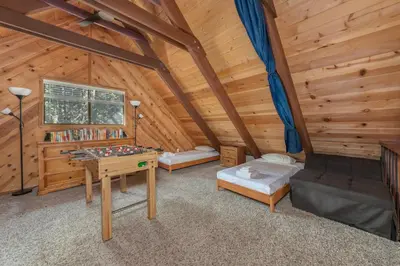 a room with a desk and a table in a cabin at Moonlit Pines in Camp Connell