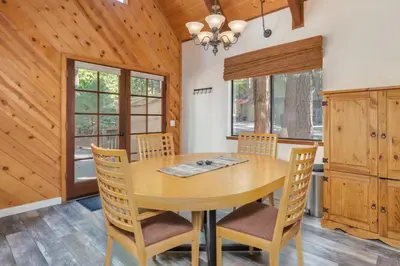 a dining room with a wooden table and chairs at Moonlit Pines in Camp Connell