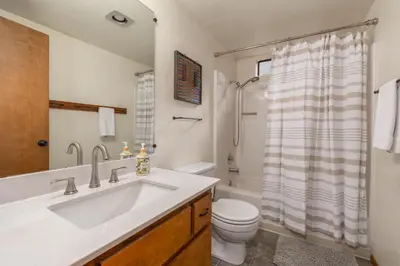 a bathroom with a sink and a toilet and a shower at Moonlit Pines in Camp Connell