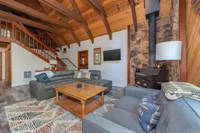 a living room with a couch and a table at Moonlit Pines in Camp Connell