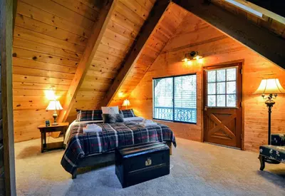 a bedroom with a bed in a wooden cabin at Grey Wolf Manor in Arnold