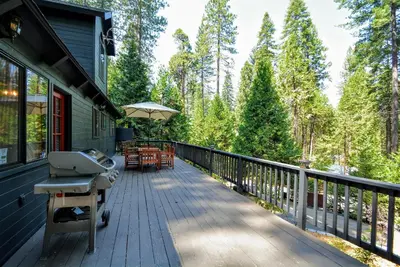 a deck with a grill and chairs on a house at Grey Wolf Manor in Arnold