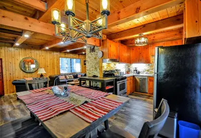 a kitchen and dining room with a table and a stove at Grey Wolf Manor in Arnold