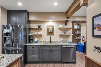 a kitchen with gray cabinets and a stainless steel refrigerator at 3BD with Hot Tub Two Minutes from King Beach in Tahoe Vista