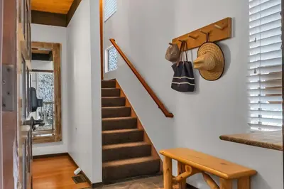 a staircase in a house with a hat on the wall at 3BD Three Minutes from King Beach in Kings Beach