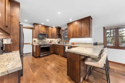 a kitchen with wooden cabinets and a counter top at Hideaway in the Highlands - 4BR, Pet Friendly w Hot Tub - Minutes from the Lake & Tahoe City in Tahoe City