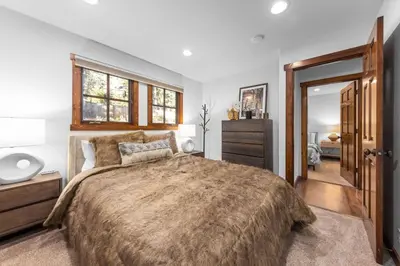 a bedroom with a large bed and a dresser at Hideaway in the Highlands - 4BR, Pet Friendly w Hot Tub - Minutes from the Lake & Tahoe City in Tahoe City
