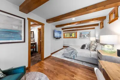 a living room with a bed and a table at Hideaway in the Highlands - 4BR, Pet Friendly w Hot Tub - Minutes from the Lake & Tahoe City in Tahoe City