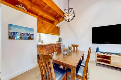 a dining room with a table and a tv at Northstar Nirvana in Truckee