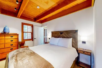 a bedroom with a bed and a wooden ceiling at Northstar Nirvana in Truckee