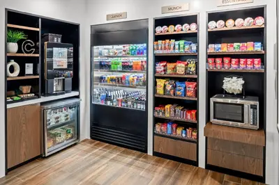 a kitchen with a refrigerator and a microwave at Courtyard by Marriott Modesto North in Modesto