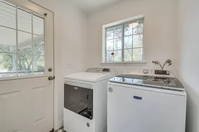 a kitchen with a stove and a washer at Bright and Cozy Mariposa Getaway 46 Mi to Yosemite! in Mariposa