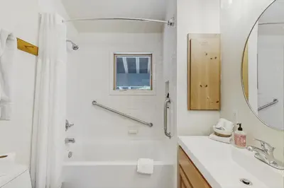 a white bathroom with a shower and a sink at The Mountain House in Soda Springs