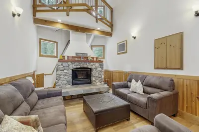a living room with two couches and a fireplace at The Mountain House in Soda Springs