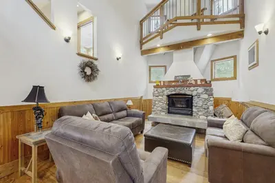 a living room with couches and a fireplace at The Mountain House in Soda Springs