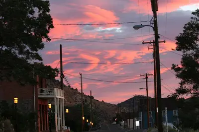 a city street at sunset with clouds in the sky at Sugarloaf Mountain Motel in Virginia City
