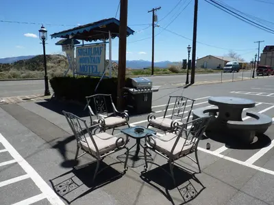 a group of chairs and a table on a street at Sugarloaf Mountain Motel in Virginia City