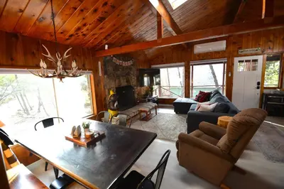 a living room with a table and a dining room at Bear Paw- Lake Area Winter Special Ends 51526 in Bass Lake