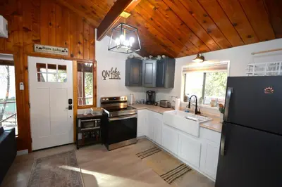 a kitchen with a black refrigerator and a sink at Bear Paw- Lake Area Winter Special Ends 51526 in Bass Lake