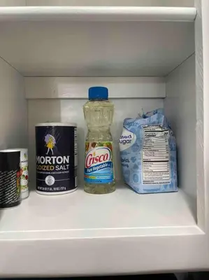 a refrigerator shelf with a bottle of honey and other groceries at Entire Modern House with King bed & 65inTV in Carmichael