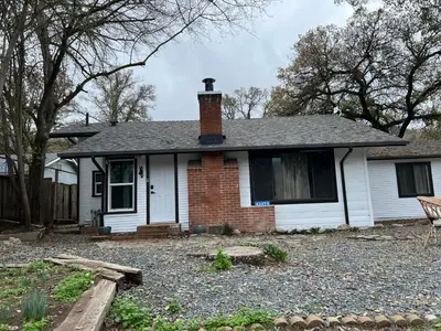 a white house with a brick chimney on top at Modern Cabin, Near Snow Park, 3.5 Miles to SNP! in Three Rivers