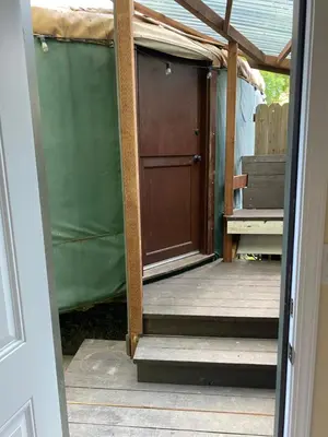 an open door to a porch with a wooden door at Seven Circles Lodge&Retreat in Badger
