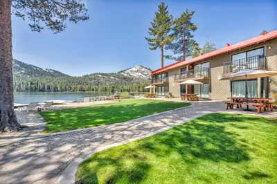 a resort building with a picnic table and a lake at Delightful Studio w/Kitchenette #111 at Donner Lake Village in Truckee