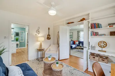 a living room with a blue couch and a table at Less Than 1 Mi to Midtown Pet-Friendly Home in Reno! in Reno