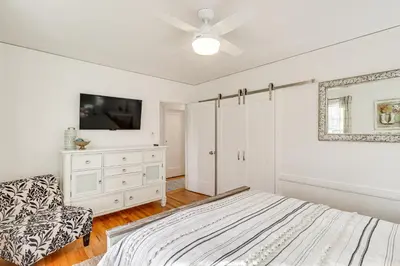 a bedroom with a bed and a tv and a chair at Less Than 1 Mi to Midtown Pet-Friendly Home in Reno! in Reno