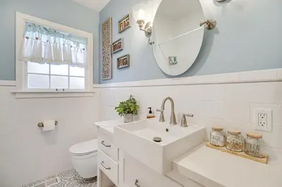a white bathroom with a sink and a mirror at Less Than 1 Mi to Midtown Pet-Friendly Home in Reno! in Reno