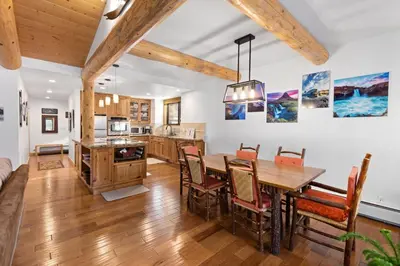 a kitchen and dining room with a wooden table and chairs at Rocky Point # 14 Palisades Townhome - Ski Shuttle w Tennis! in Olympic Valley