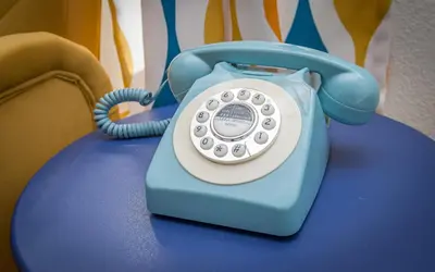 a blue phone sitting on top of a table at Retro Casita on the River! only 1 min to SNP gate! Riverfront with swimming in Three Rivers