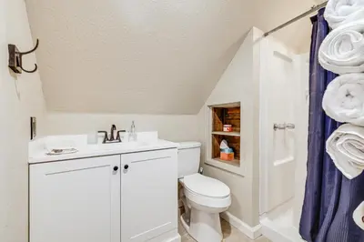 a white bathroom with a toilet and a sink at Serene Cabin Retreat Between Murphys and Arnold in Murphys