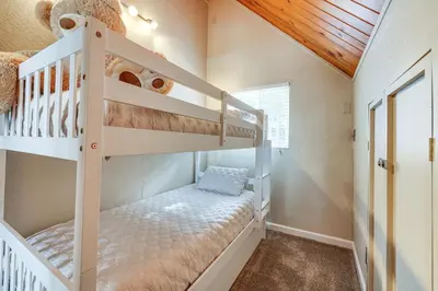 a childs room with two bunk beds and a wooden ceiling at Serene Cabin Retreat Between Murphys and Arnold in Murphys