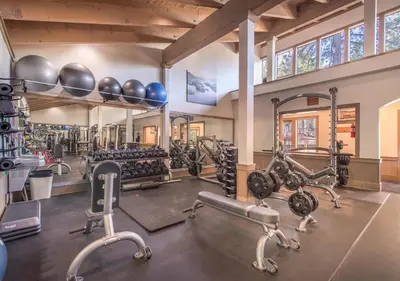 a gym with several tread machines and exercise bikes at Northstar Resort Condo for 8 Free Shuttle in Truckee