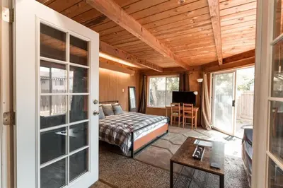 a bedroom with a bed and a table in a room at SunHouse 1410sqft BBQ 3xTVs Pets W/D Backyard in Sacramento