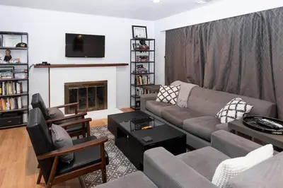 a living room with a couch and a fireplace at SunHouse 1410sqft BBQ 3xTVs Pets W/D Backyard in Sacramento