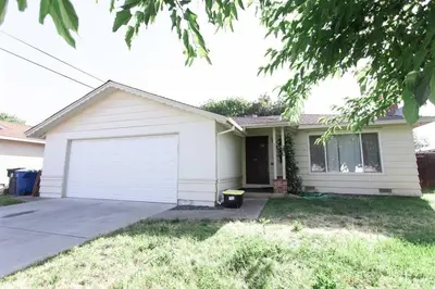 a white house with a white garage at SunHouse 1410sqft BBQ 3xTVs Pets W/D Backyard in Sacramento