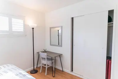 a bedroom with a table and a lamp and a bed at Arden Family Home BBQ Big Kitchen Backyard Pet W/D in Sacramento