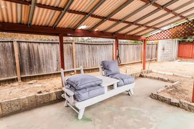 a pergola with two chairs on a patio at Arden Family Home BBQ Big Kitchen Backyard Pet W/D in Sacramento