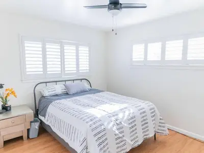 a white bedroom with a bed and a ceiling fan at Arden Family Home BBQ Big Kitchen Backyard Pet W/D in Sacramento