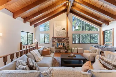 a living room with couches and a fireplace at The Pinecrest Retreat- 10 mins to NorthStar! Hot Tub, Large Deck, Views, and Games in Tahoe Vista