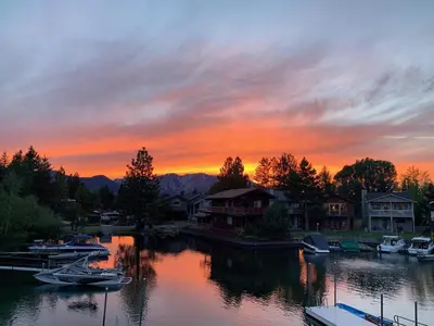 a sunset over a marina with boats in the water at Tahoe Waterfront Condo with Boat Dock in South Lake Tahoe