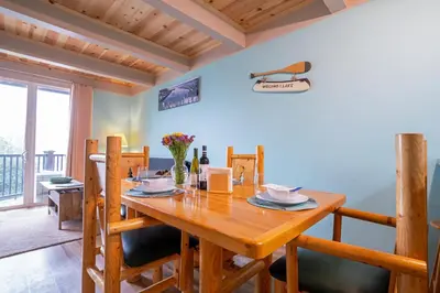 a dining room with a wooden table and chairs at Tahoe Waterfront Condo with Boat Dock in South Lake Tahoe