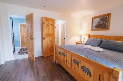 a bedroom with a wooden bed with a wooden floor at Tahoe Waterfront Condo with Boat Dock in South Lake Tahoe