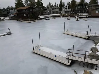 an ice rink is covered in snow with benches on it at Tahoe Waterfront Condo with Boat Dock in South Lake Tahoe
