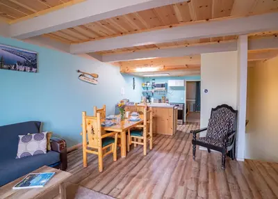 a living room and kitchen with a table and chairs at Tahoe Waterfront Condo with Boat Dock in South Lake Tahoe