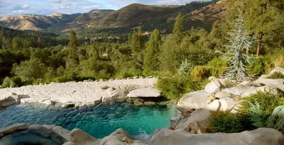 a pool of blue water with mountains in the background at Bella Vista Bed and Breakfast in Coloma