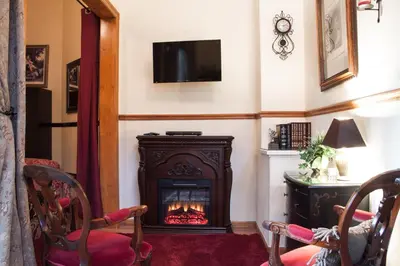 a living room with a fireplace and a tv at Bella Vista Bed and Breakfast in Coloma